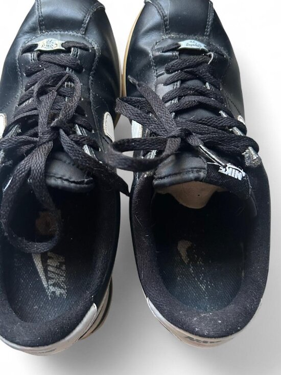 black and white Nike Cortez sneakers feature signature \